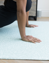 Lady enjoys stretching on a foam pilates floor mat that doubles up as an area rug in the family home