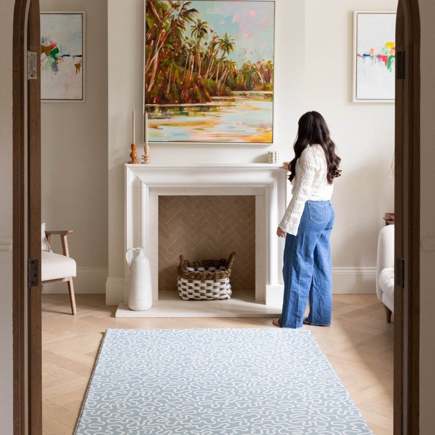 A sophisticated living room interior featuring a large soft blue rug-like play mat