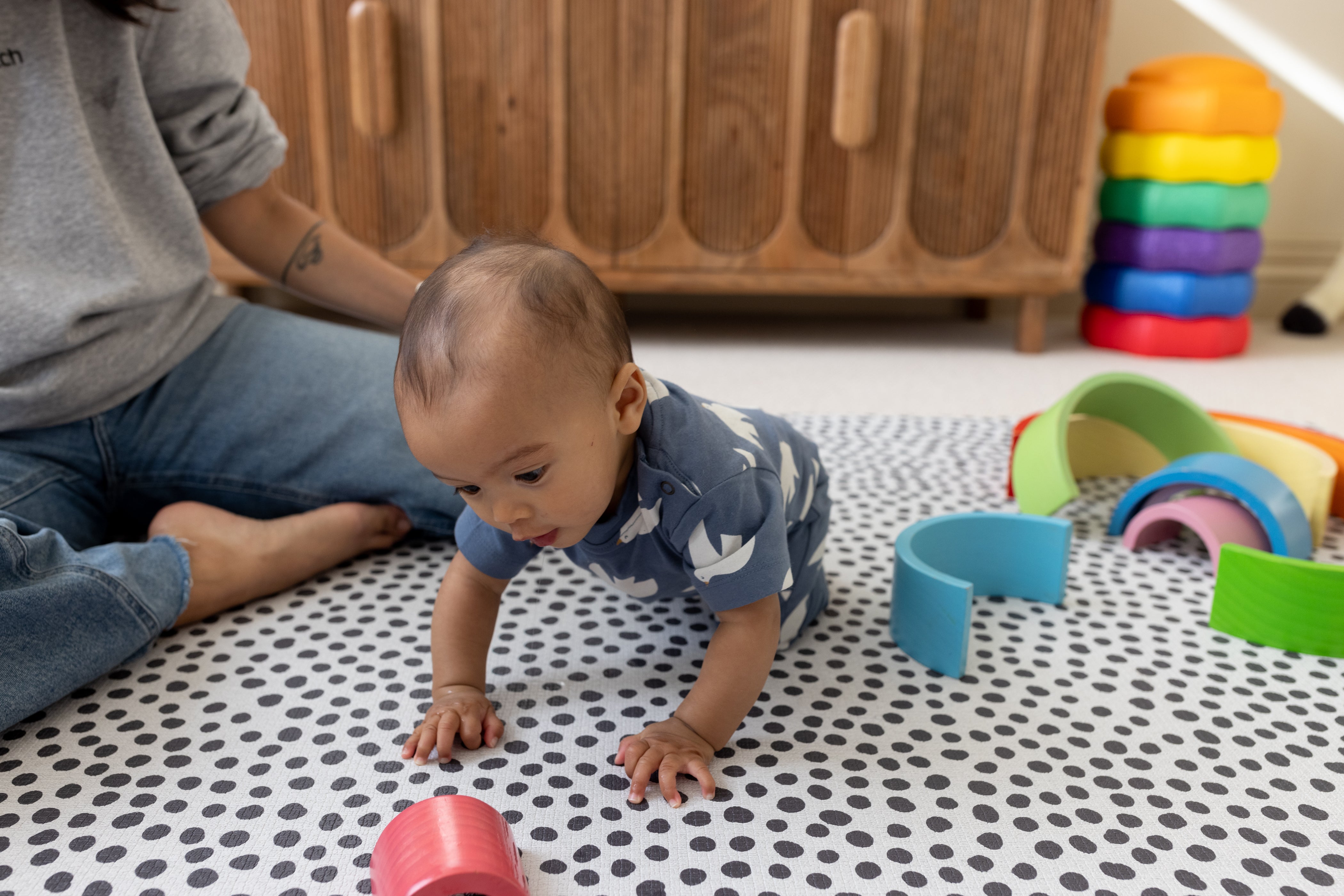 Baby crawling and learning on Totter + Tumble reversible Scout play mat
