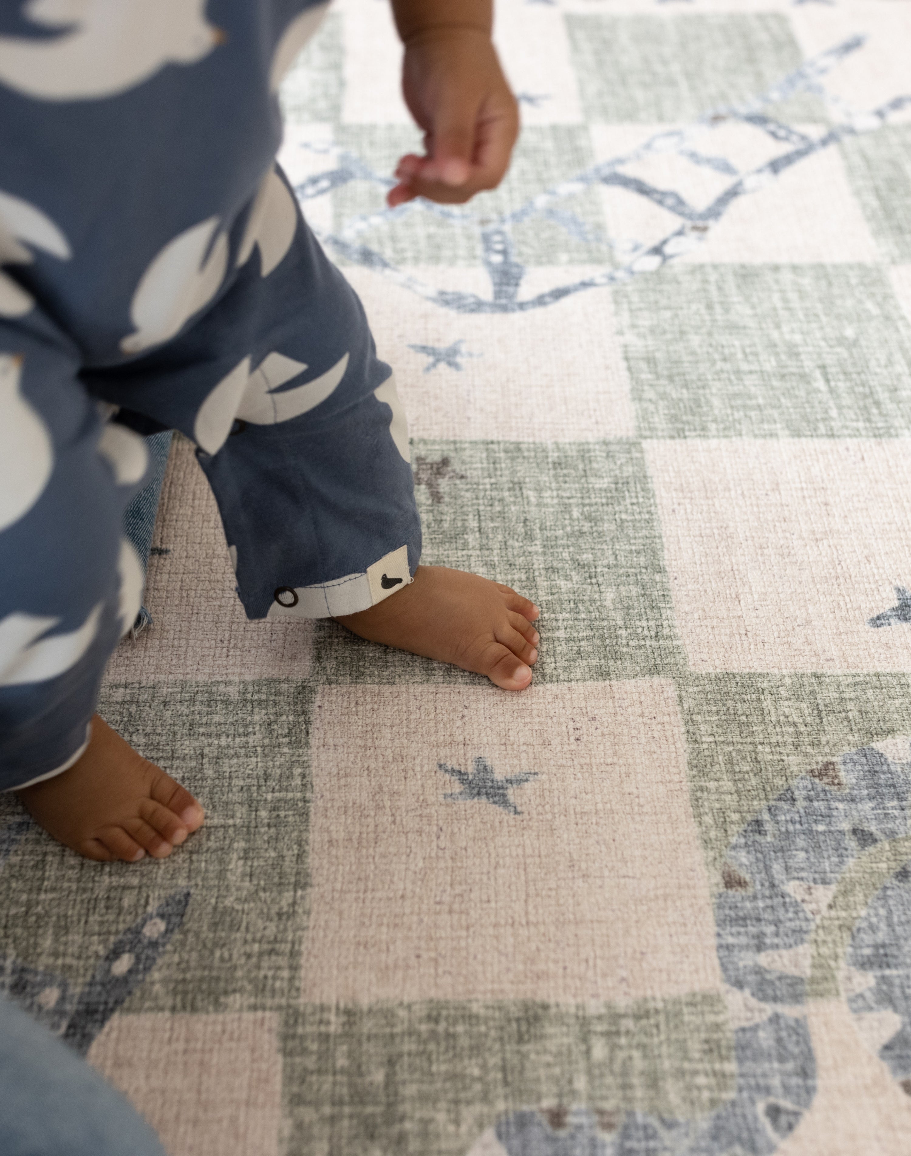 Child stood on a super soft supportive luxury memory foam totter and tumble play mat