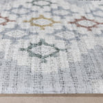 Close-up of a patterned play mat with geometric designs on a neutral background