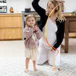Woman and child playing in the kitchen on a geometric pattern play mat