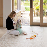 Woman and child playing on a rug-like comfortable floral play mat 