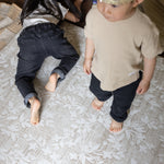 two children playing comfortably on a memory foam rug-like design play mat