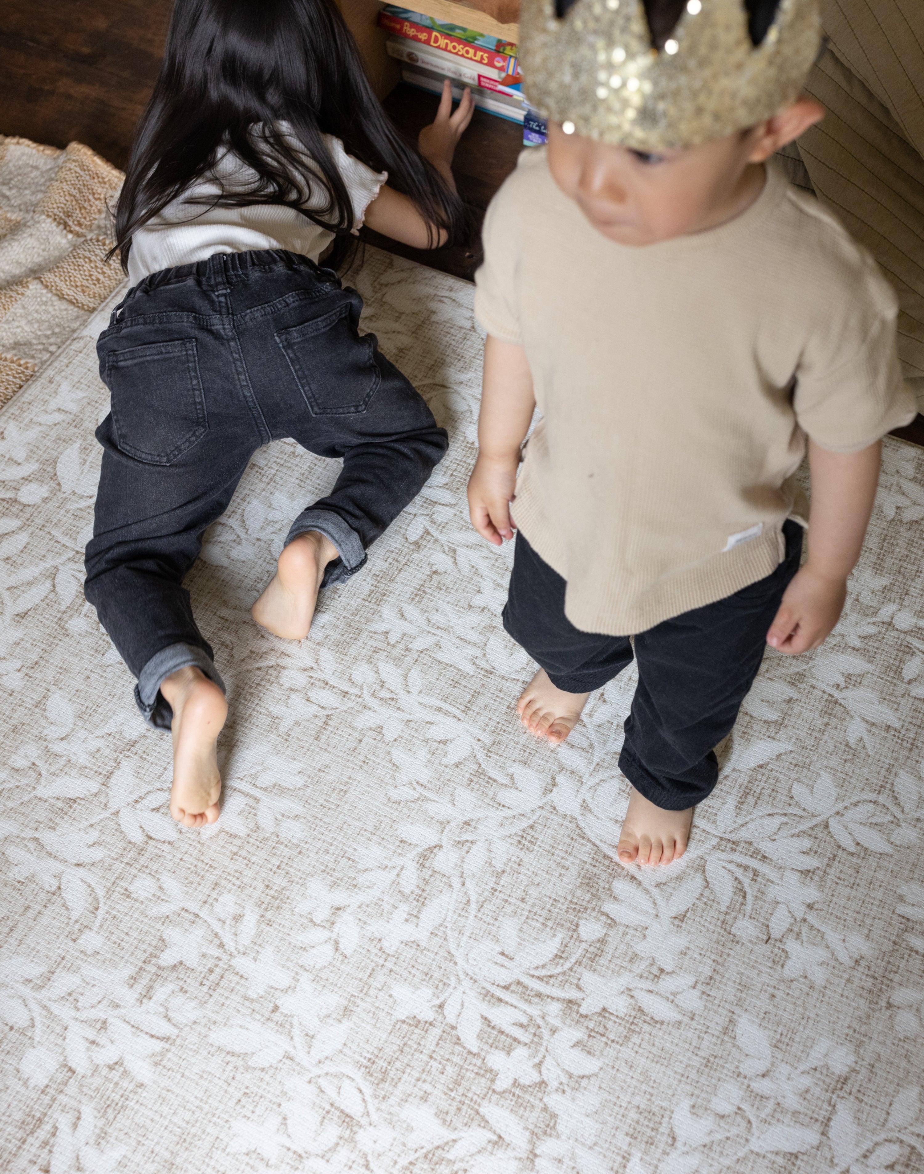 two children playing comfortably on a memory foam rug-like design play mat