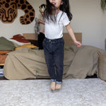 Child jumping on a thick memory foam floral play mat
