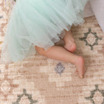 Childs feet on a comfy pink memory foam totter and tumble play mat