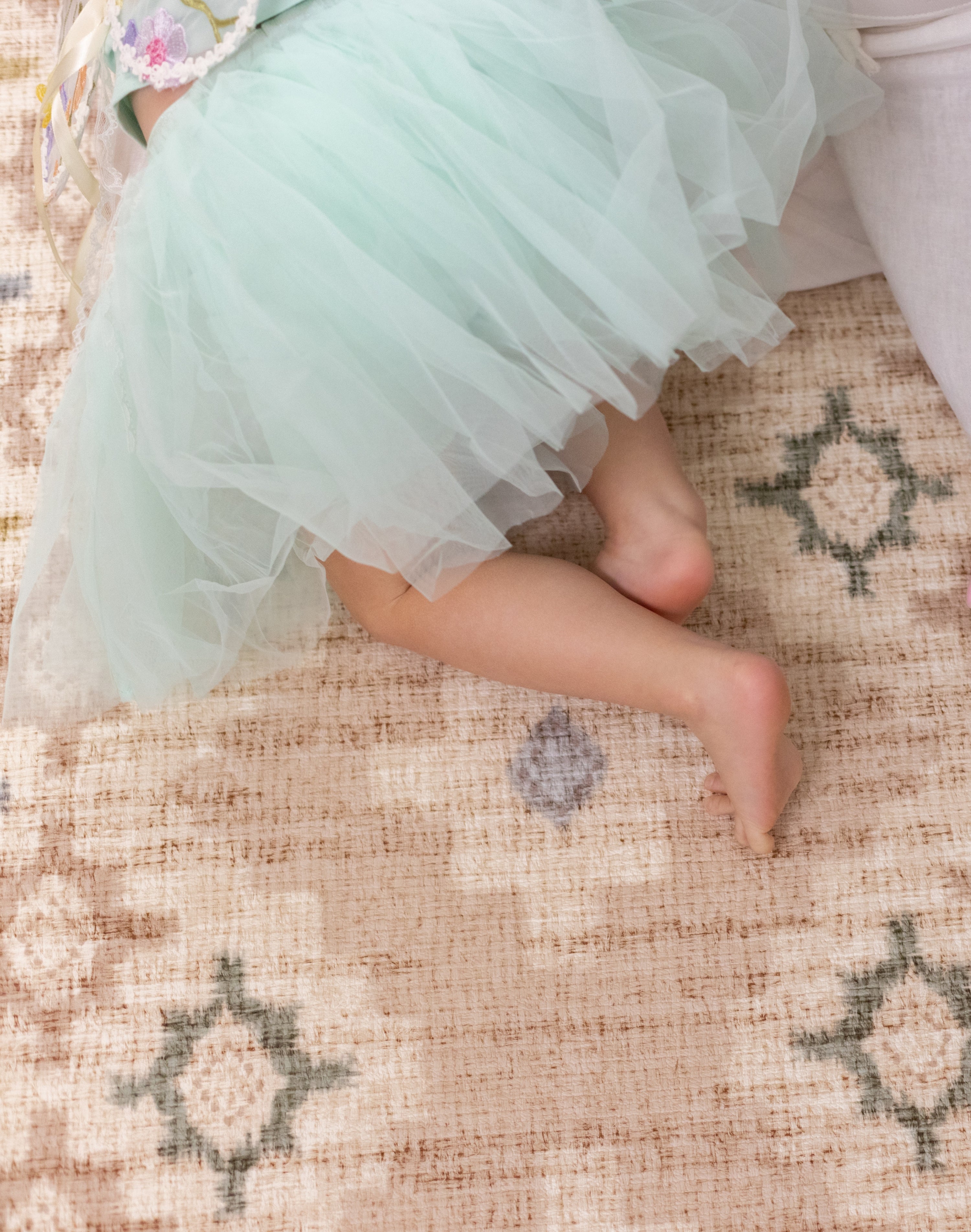 Childs feet on a comfy pink memory foam totter and tumble play mat