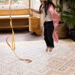 Child jumping on a super soft memory foam rug-like play mat