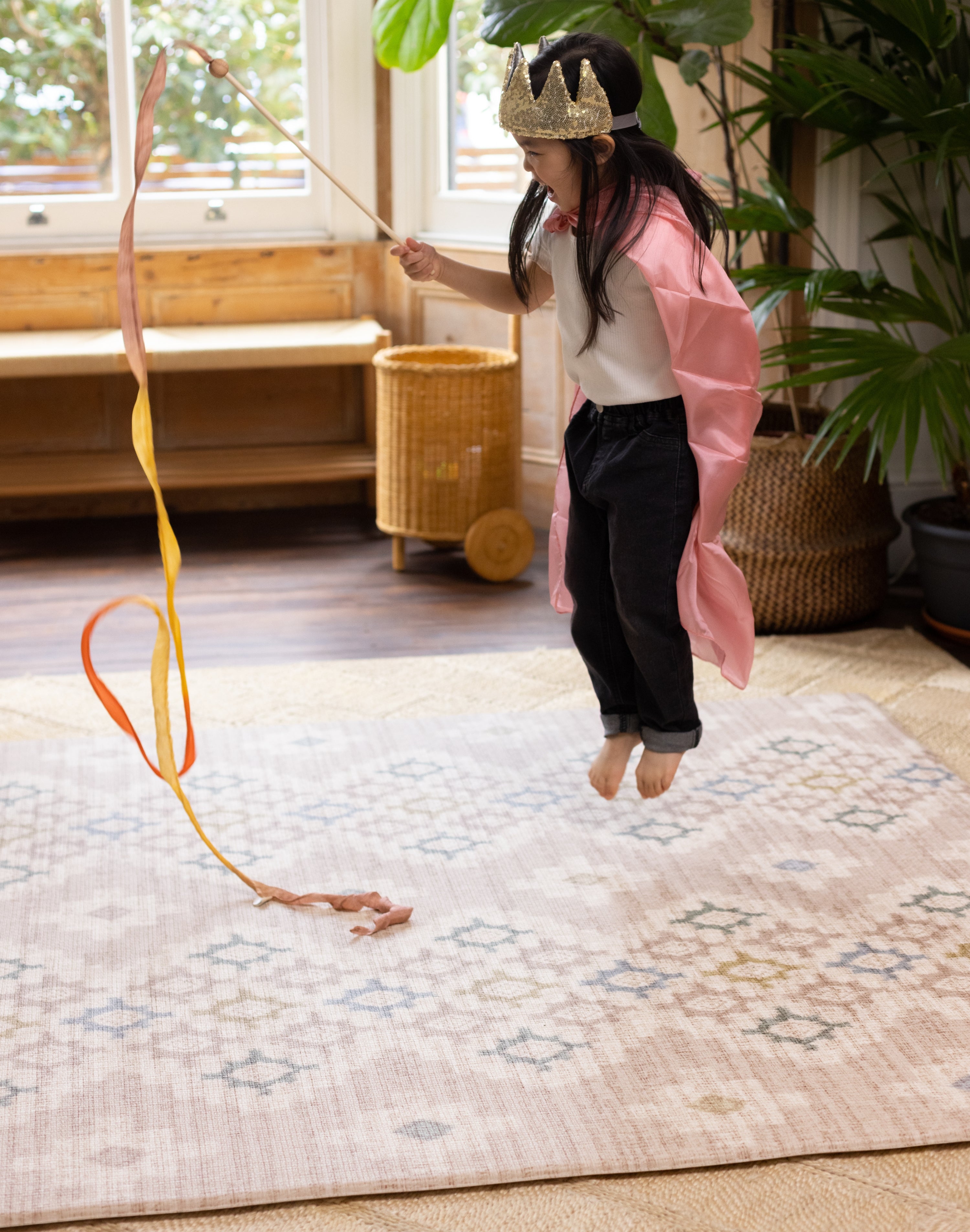 Child jumping on a super soft memory foam rug-like play mat