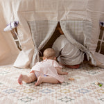 Children playing on a thick soft geometric pink play mat