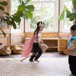 child playing on a large patterned play mat in a living room