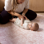 Woman and baby on safe non toxic pink floral totter and tumble play mat