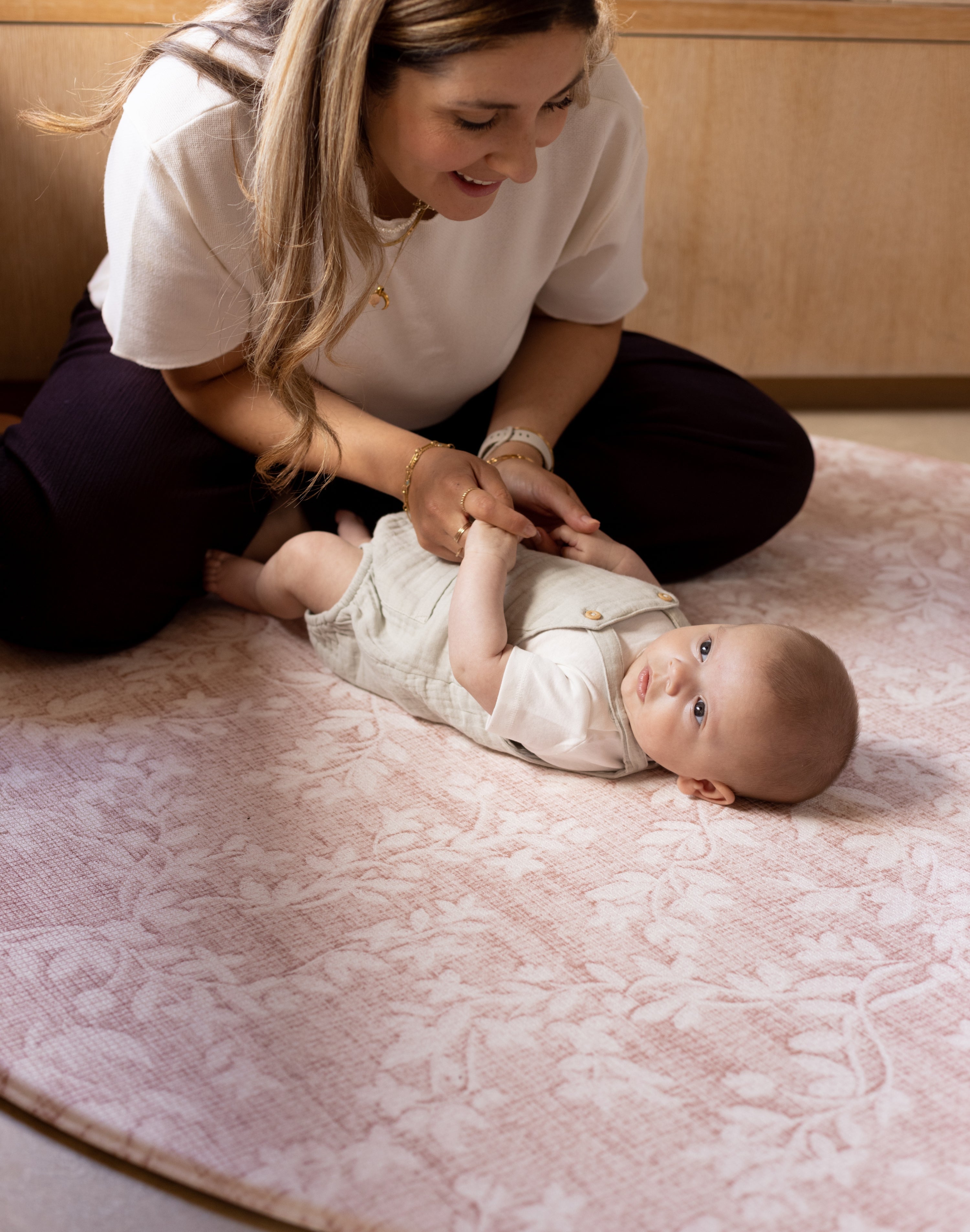 Woman and baby on safe non toxic pink floral totter and tumble play mat