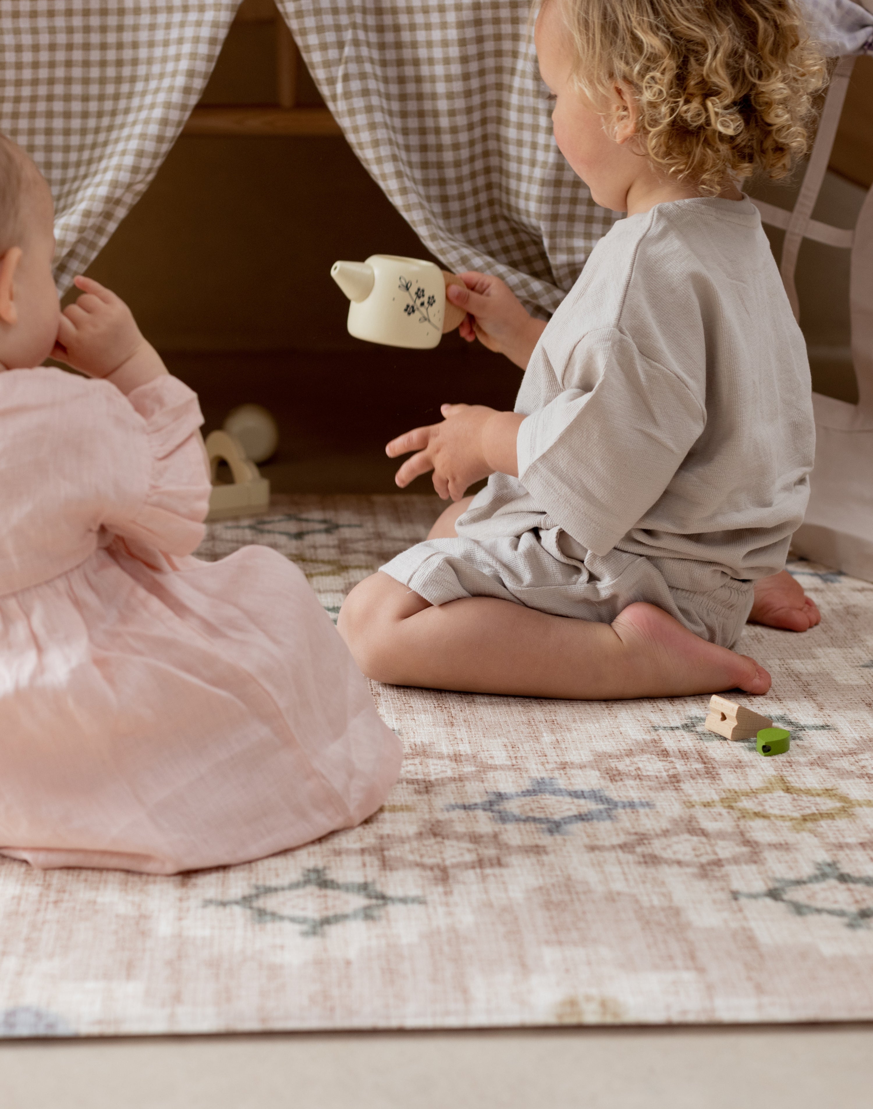 two children sat on a comfortable memory foam baby safe play mat