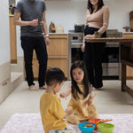 Family in the kitchen with a totter and tumble aster play mat