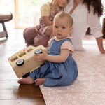 Child sat on a thick comfortable memory foam totter and tumble play mat