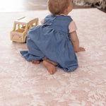 Baby on a safe non toxic point floral totter and tumble play mat