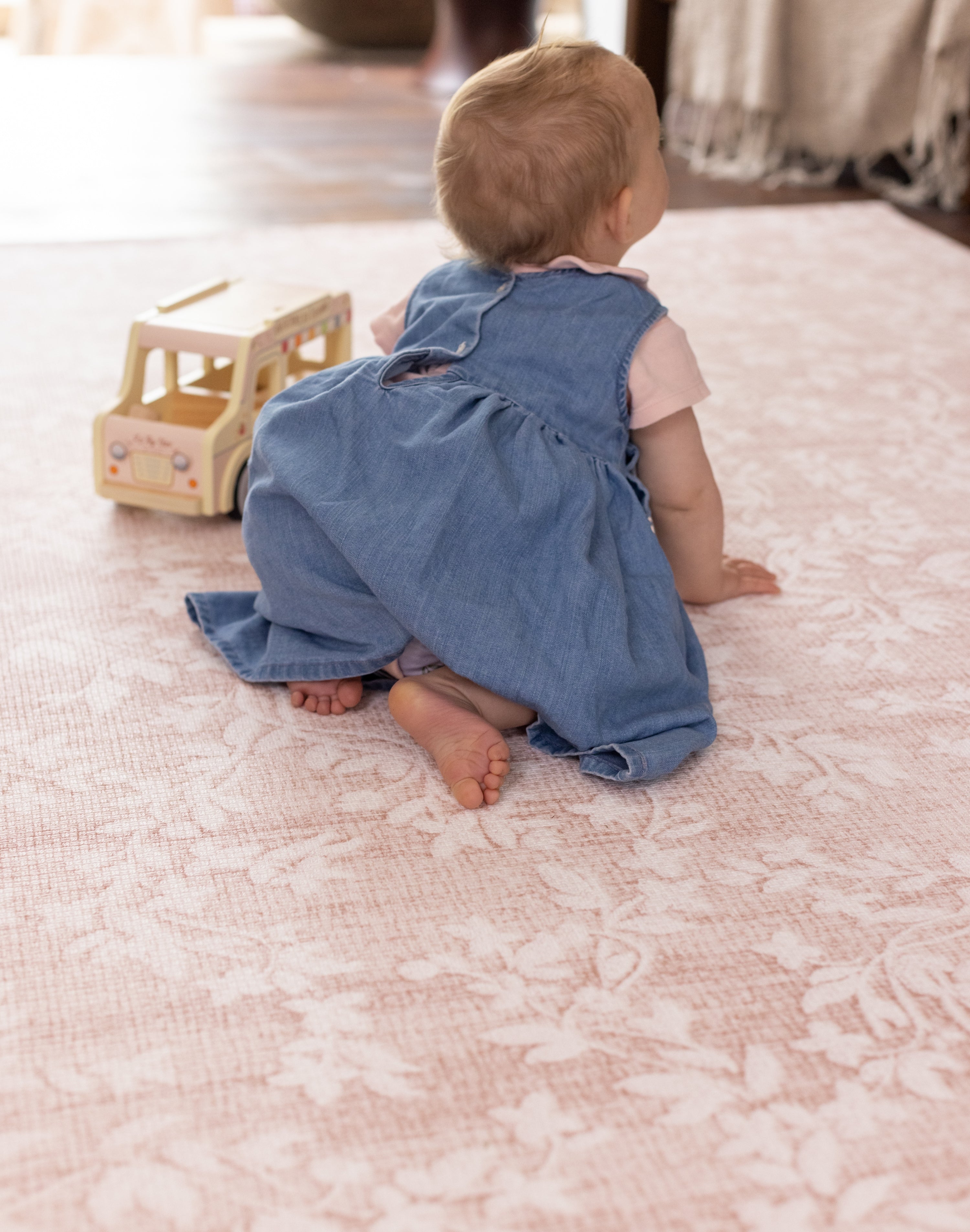Baby on a safe non toxic point floral totter and tumble play mat