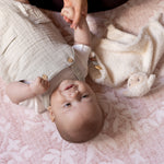 Baby lying on a soft safe non toxic play mat