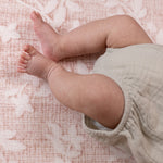 Baby's feet on the floral pink aster totter and tumble play mat