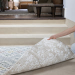 person showing two sides of a thick memory foam reversible play mat with geometric and floral designs