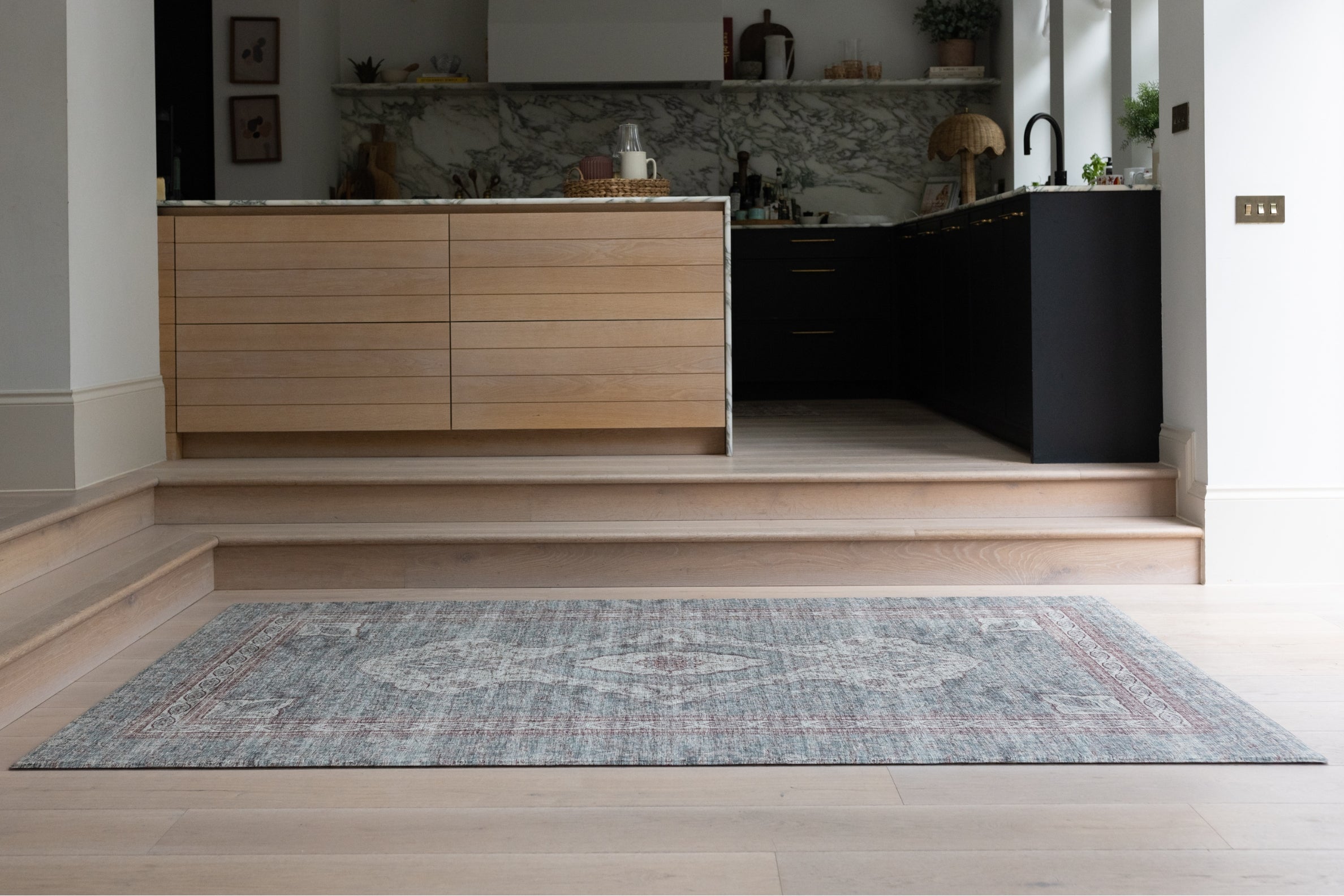 Modern kitchen with a stylish extra large play mat in a Persian rug style