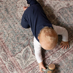 Young child playing on Totter + Tumble soft washable play mat.
