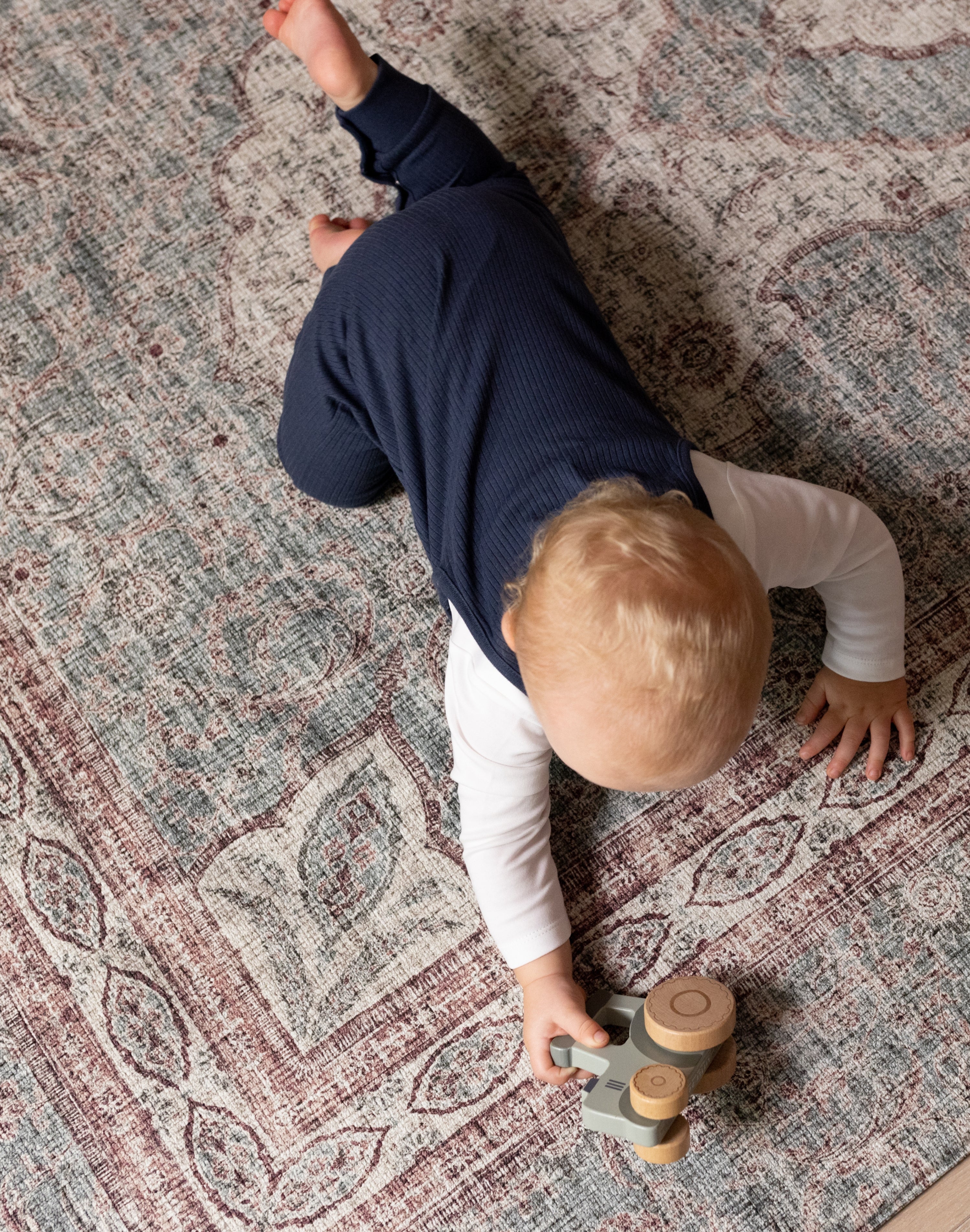Young child playing on Totter + Tumble soft washable play mat.