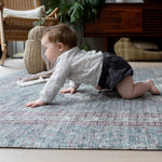 Baby crawling across Totter + Tumble mat in a cosy modern home.