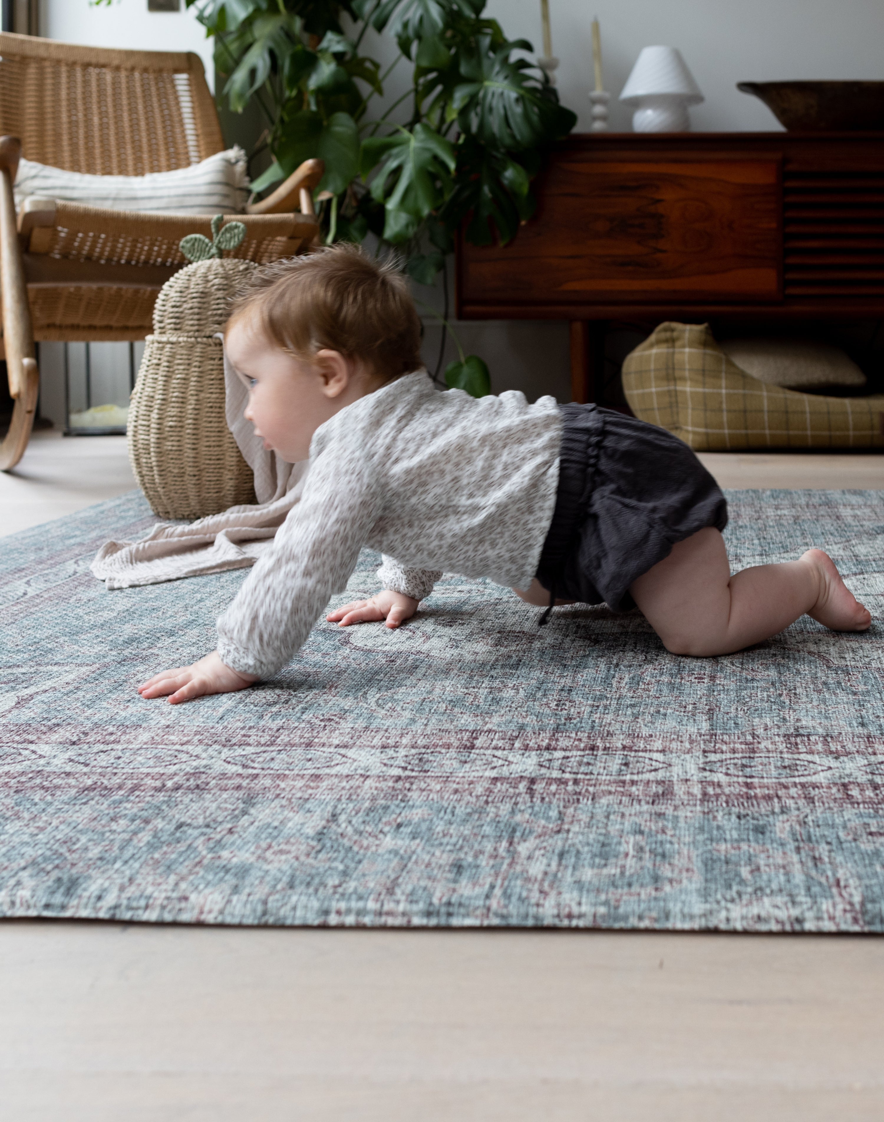 Baby crawling across Totter + Tumble mat in a cosy modern home.