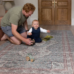 Dad and toddler playing together on Totter + Tumble padded play mat.