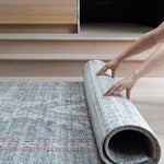 Rolling up a Totter & Tumble play mat to show flexible, easy to store design.