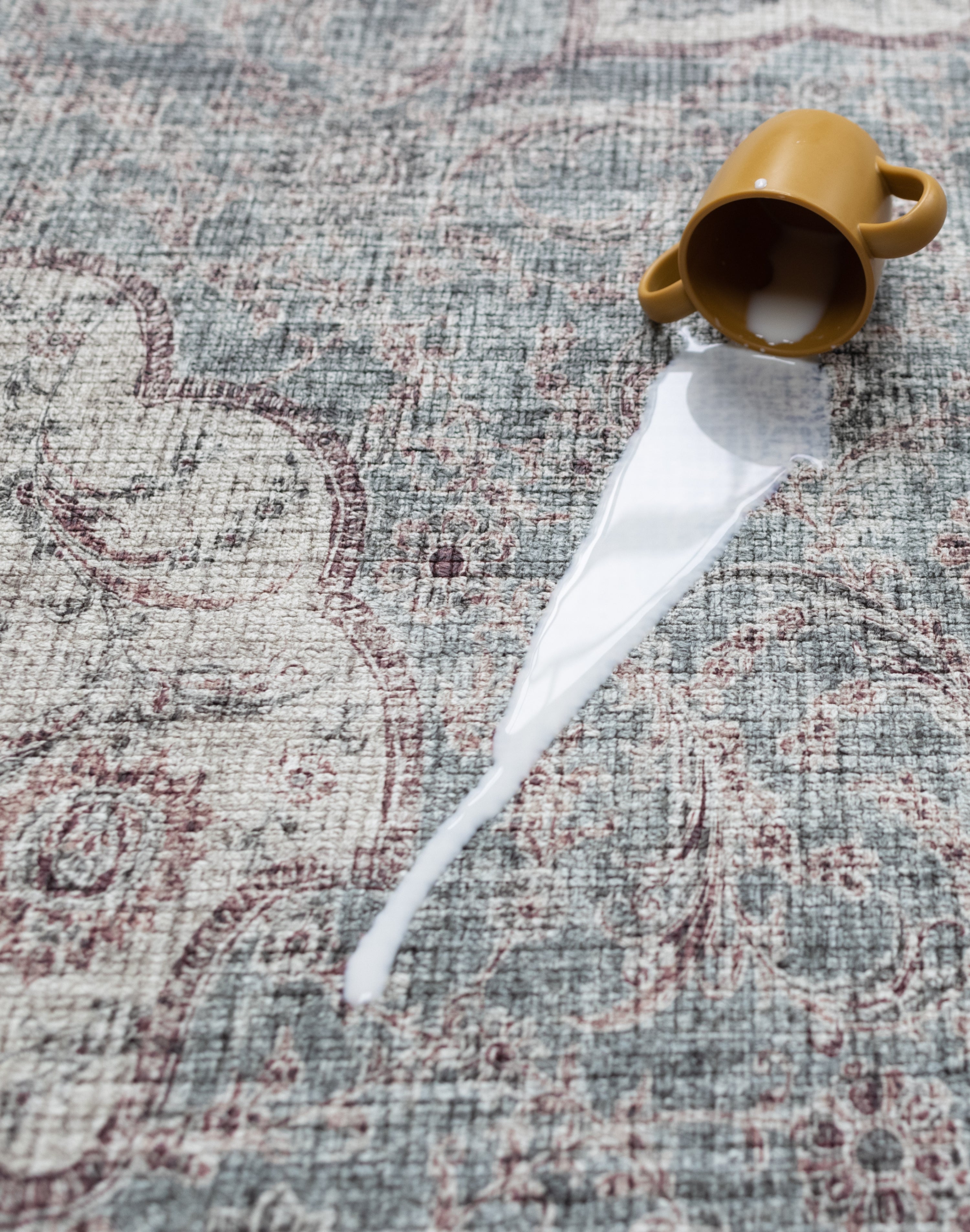 Drink spill on Totter & Tumble mat showing easy-wipe, waterproof surface.