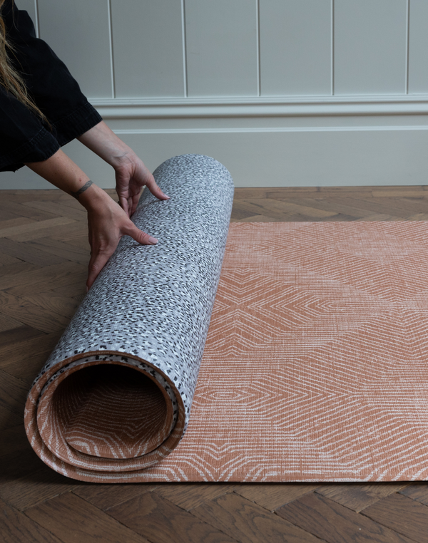 Unrolling the playmat rug by totter and tumble with a modern leopard and kilim motif for more choice in the home