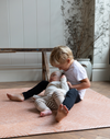 Toddler and baby play on the terracotta foam play mat by totter and tumble for comfortable play time