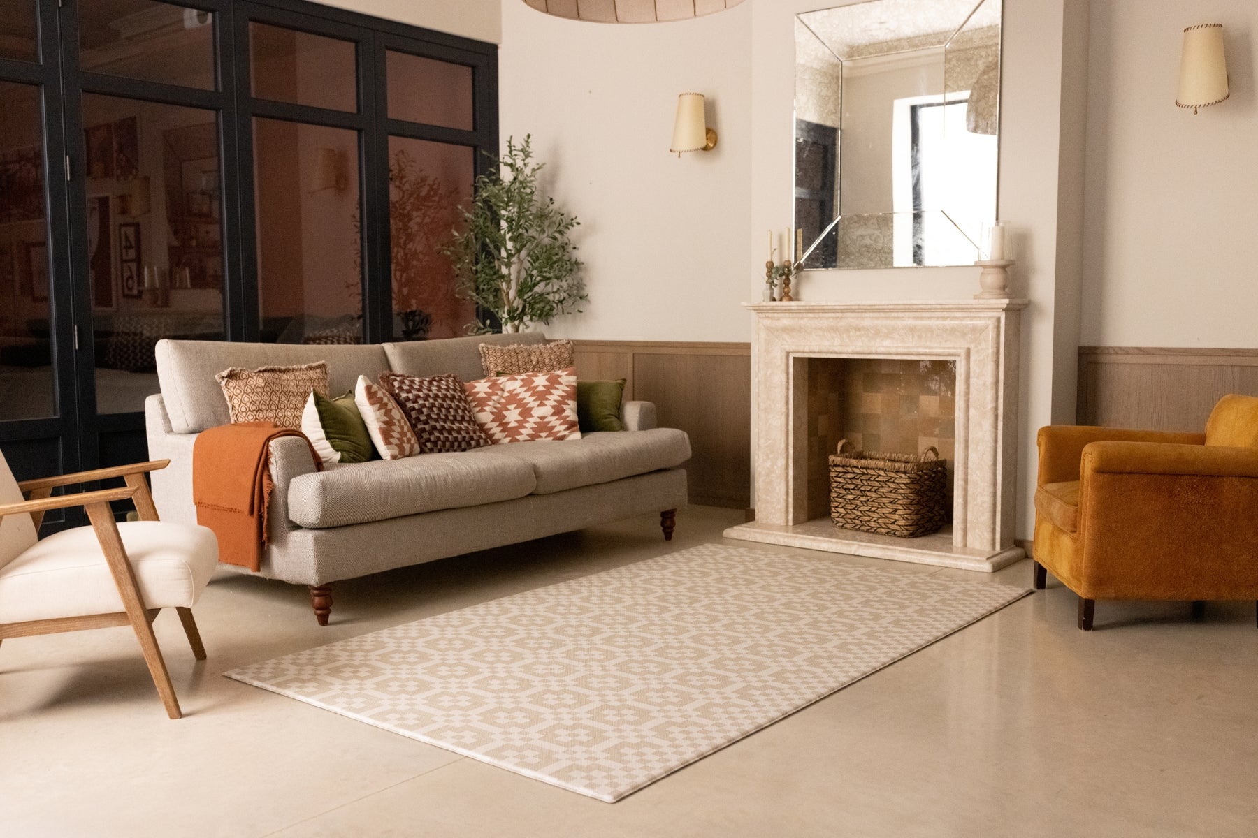 A living room setting with a soft neutral play mat for children