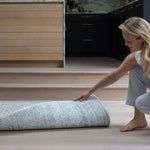 Unrolling a reversible play mat in a modern kitchen