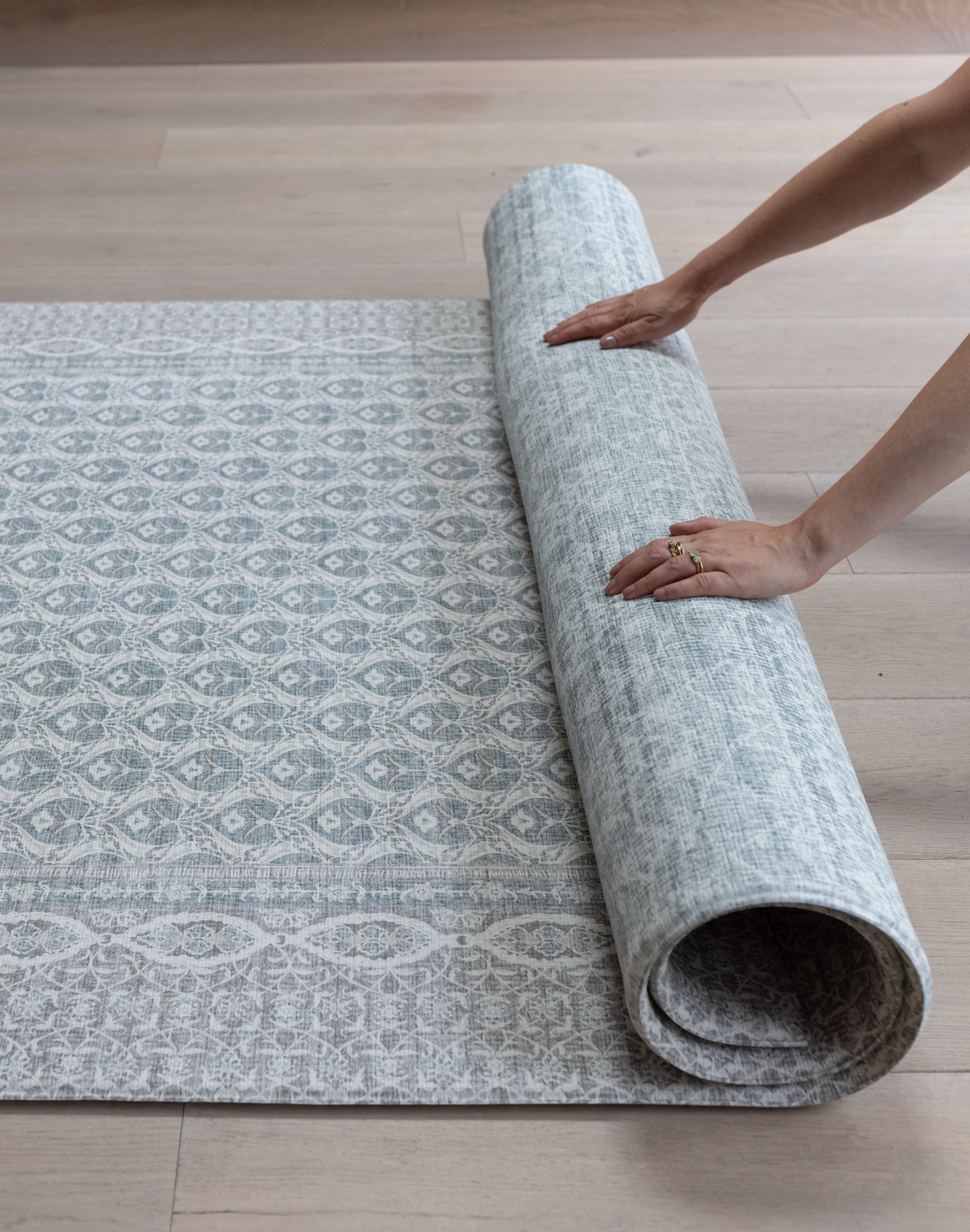 Rolling up large soft baby mat for easy storage
