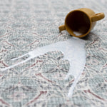 An easy to clean spill on a Totter and Tumble baby mat with a dusty pink and sage green pattern