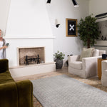Spacious modern lounge with Totter + Tumble soft green baby rug