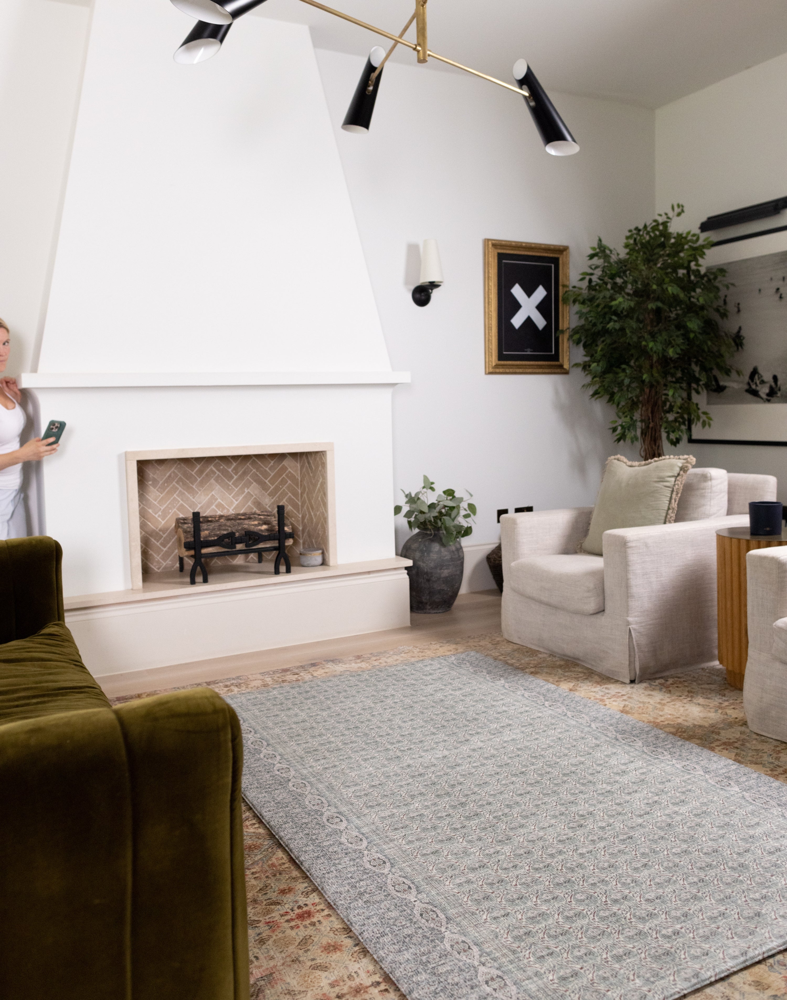 Spacious modern lounge with Totter + Tumble soft green baby rug