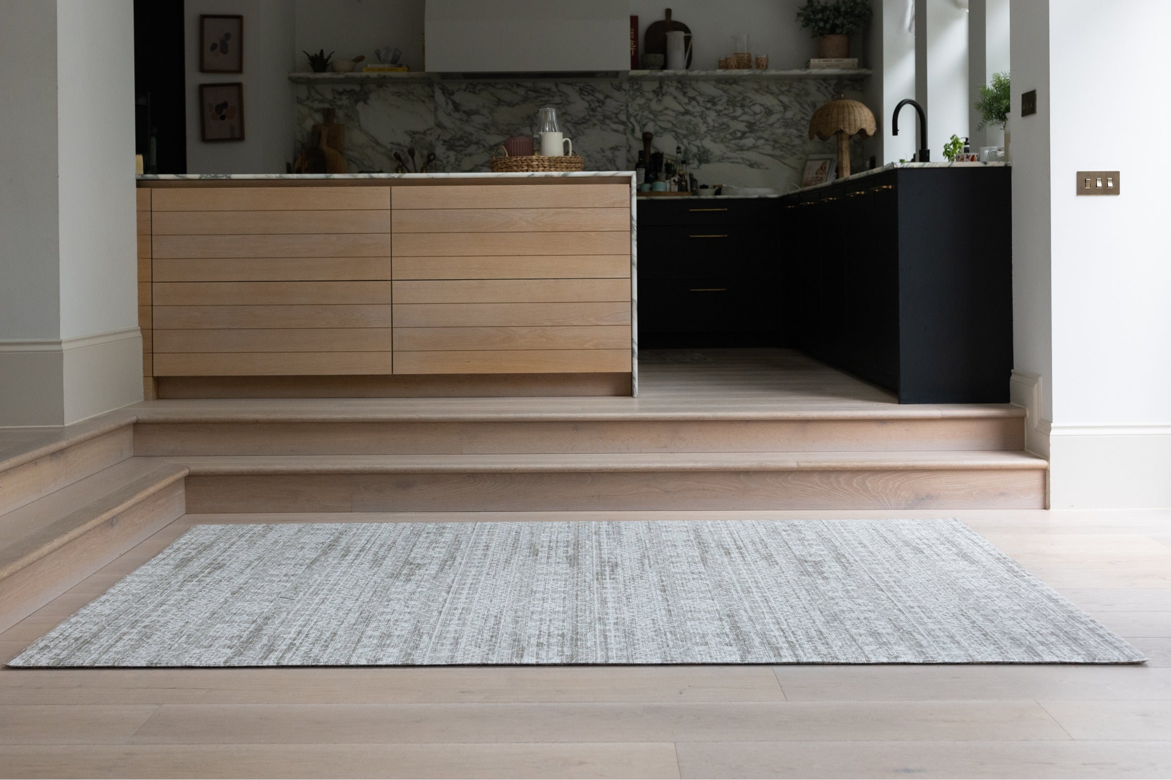 A large textured crawling mat in a kitchen