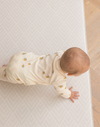 Baby crawls on thick memory foam play mat that makes movement more comfortable on hard wood flooring