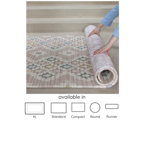 pink, neutral reversible geometric and floral play mat being rolled up, available in 5 sizes