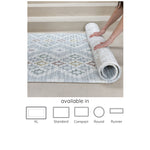 blue, neutral reversible geometric and floral play mat being rolled up, available in 5 sizes