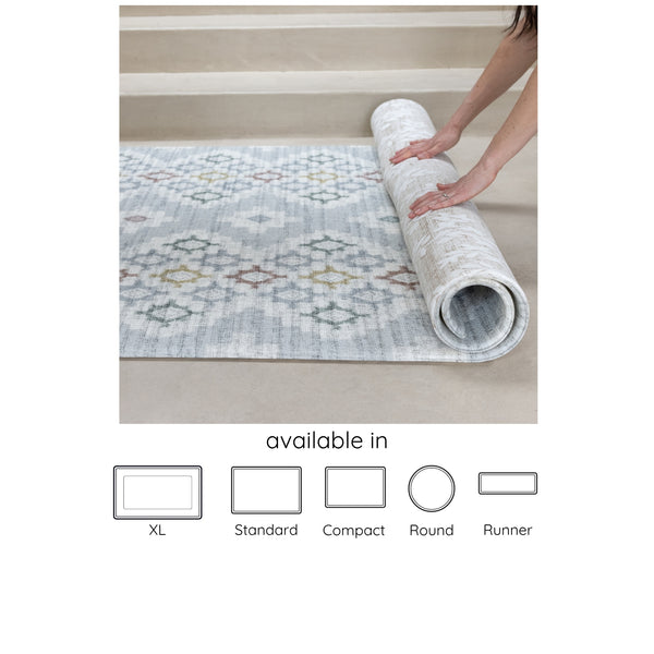 blue, neutral reversible geometric and floral play mat being rolled up, available in 5 sizes