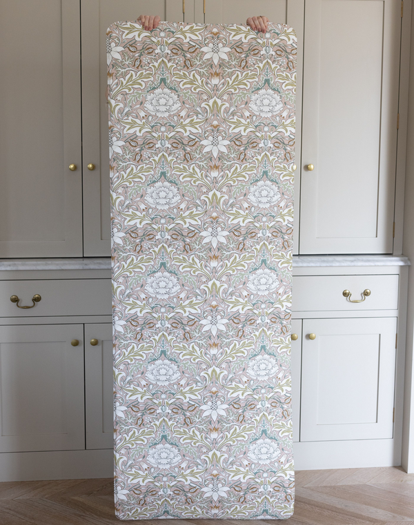 Holding up the memory foam Play Runner by Totter and Tumble with stylish Severn print from the Morris & Co. archives ideal for narrow spaces and as a supportive standing mat in the home