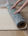 one-piece foam play mat rolled in double-sided morris & co designs The Standen and The Blackthorn totter + tumble foam mats that look like rugs