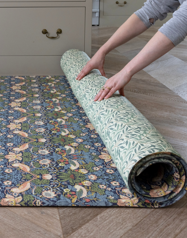 Unrolling double sided play mat with Strawberry Thief and Willow Boughs designs both from William Morris archive simple to flip from one side to the other perfect play mat for family homes